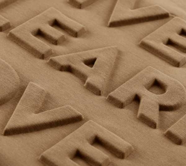 Embossed apparel example on light brown fabric