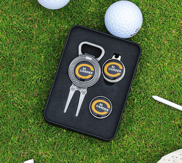 Divot tool and ball markers with branded logo in grass